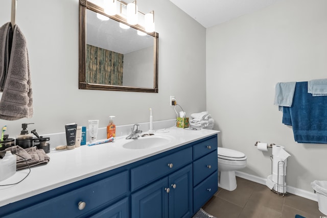 bathroom with vanity, tile patterned floors, toilet, and baseboards