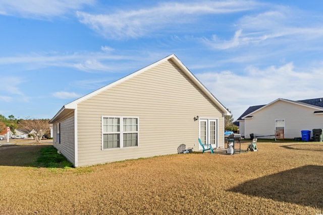 back of property featuring a lawn