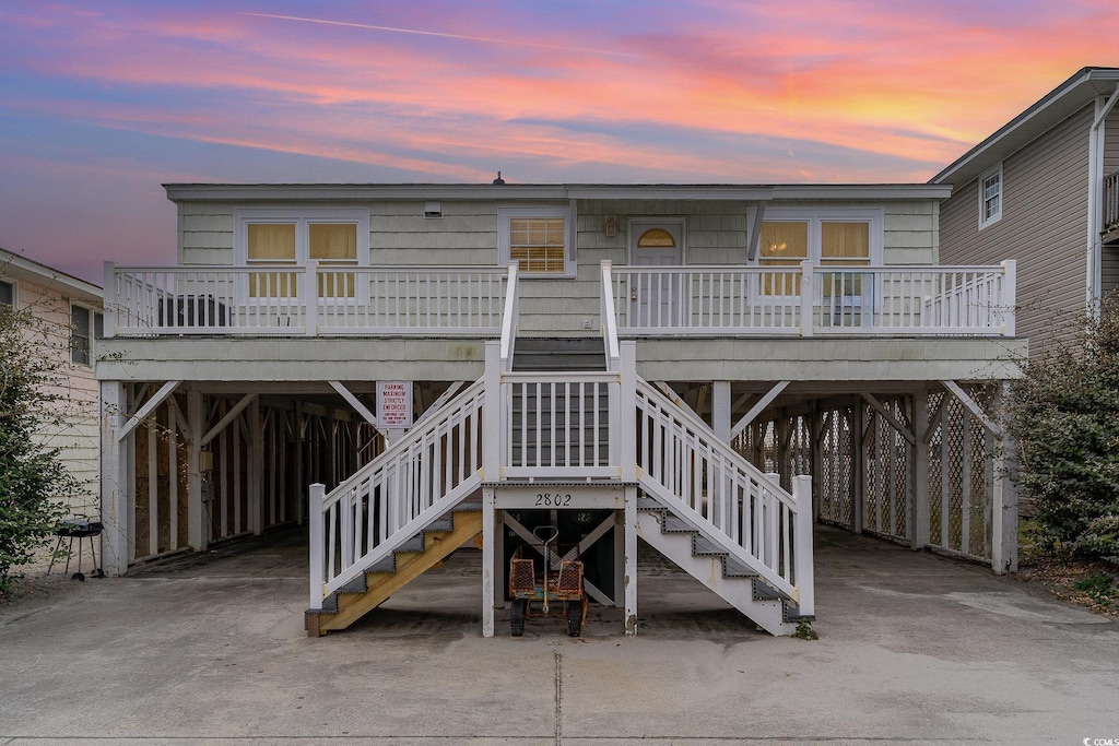 back house at dusk with a porch