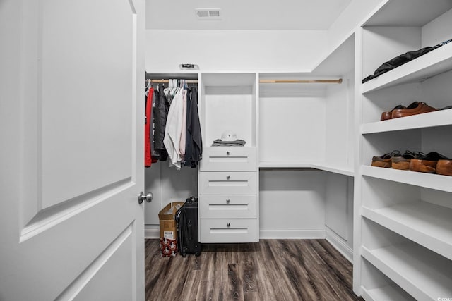 spacious closet with dark hardwood / wood-style floors