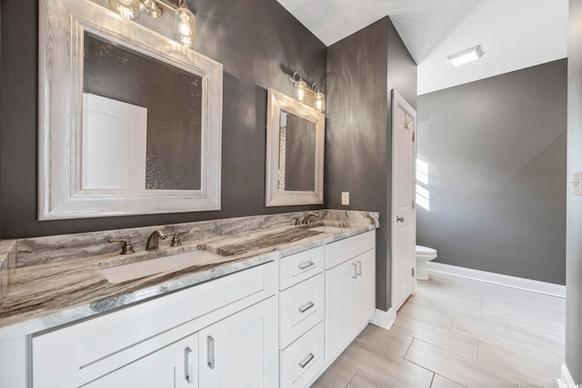 bathroom featuring tile patterned floors, vanity, and toilet