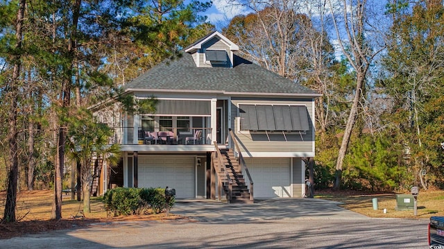 view of front of property with a balcony and a garage