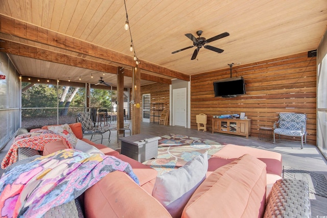 living room with ceiling fan, wood walls, wooden ceiling, and track lighting