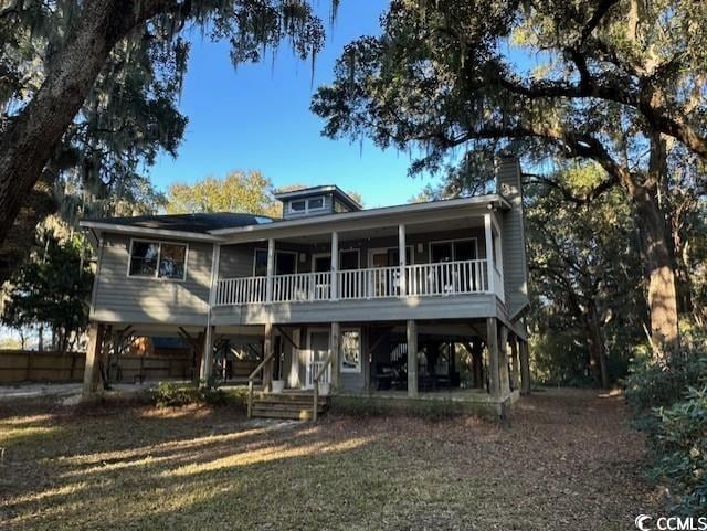 coastal home featuring a front lawn