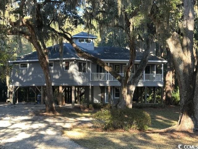 back of house featuring a carport