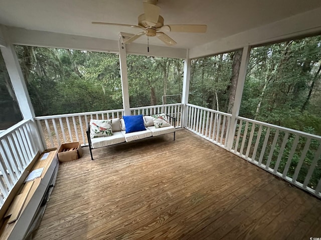 wooden deck with outdoor lounge area and ceiling fan