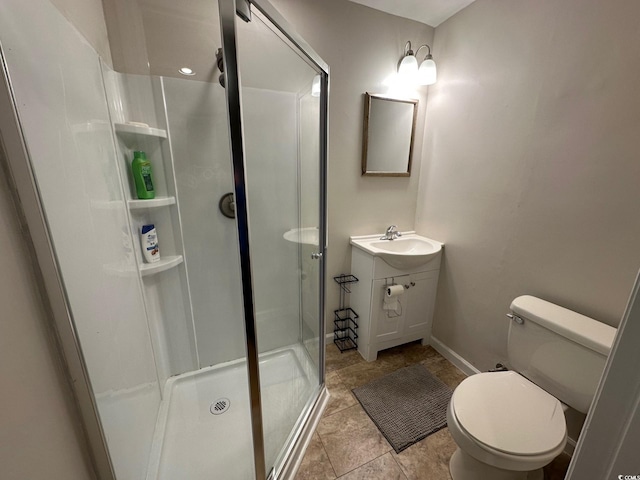 bathroom featuring a shower with door, vanity, and toilet