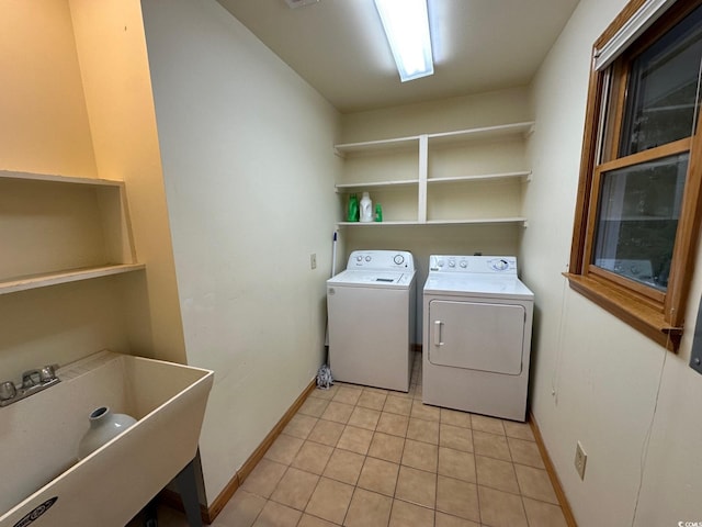 washroom with washing machine and clothes dryer, sink, and light tile patterned floors