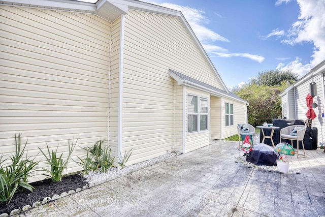 view of side of property featuring a patio area