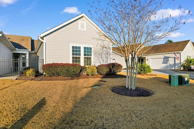 view of front of house with a front yard and a garage