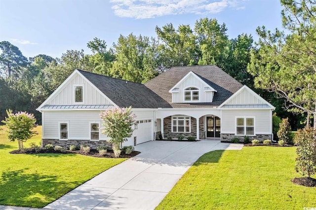 view of front of property with a front yard and a garage