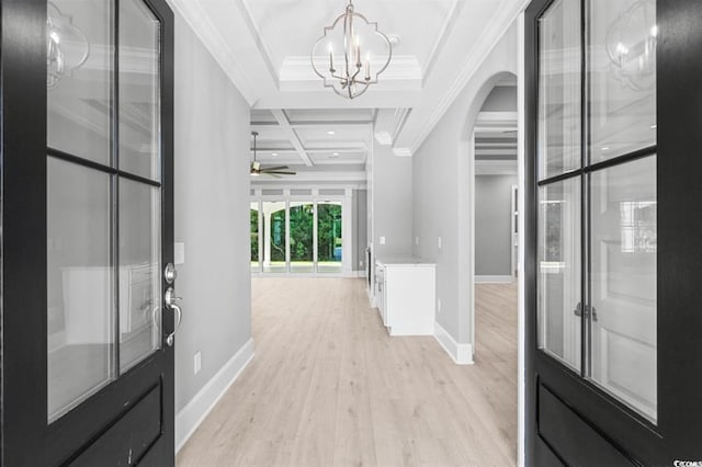 entrance foyer featuring ornamental molding, coffered ceiling, ceiling fan with notable chandelier, light hardwood / wood-style flooring, and beamed ceiling