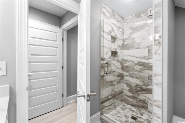 bathroom featuring wood-type flooring and an enclosed shower