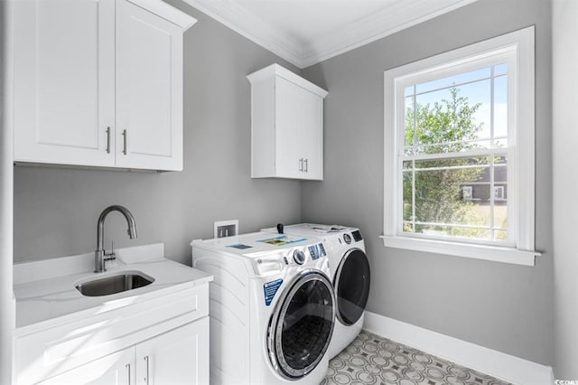 washroom featuring cabinets, washing machine and clothes dryer, crown molding, and sink