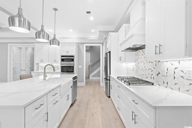 kitchen with white cabinets, pendant lighting, a large island, and custom exhaust hood