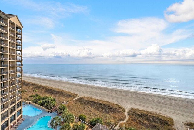 balcony with a water view and a beach view