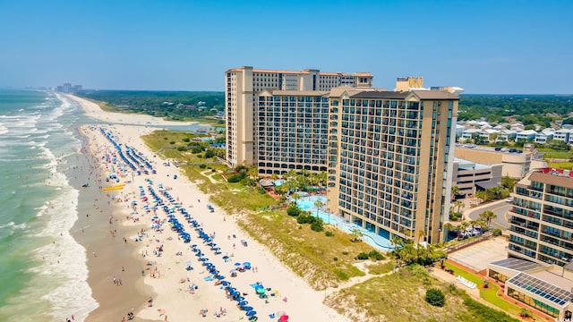 bird's eye view featuring a water view and a beach view