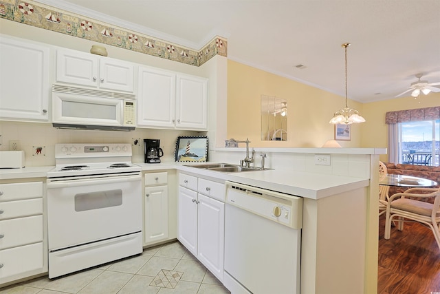 4240 Coquina Harbour Dr Unit E-4, Little River, SC 29566 - kitchen with white appliances, light countertops, a sink, and a peninsula