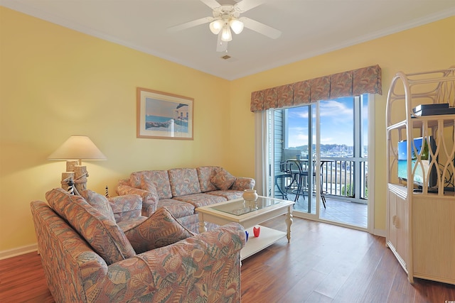 living room with hardwood / wood-style floors, ceiling fan, and crown molding