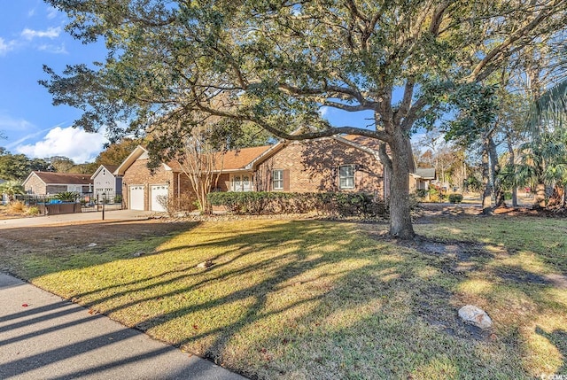 ranch-style house featuring a garage and a front yard