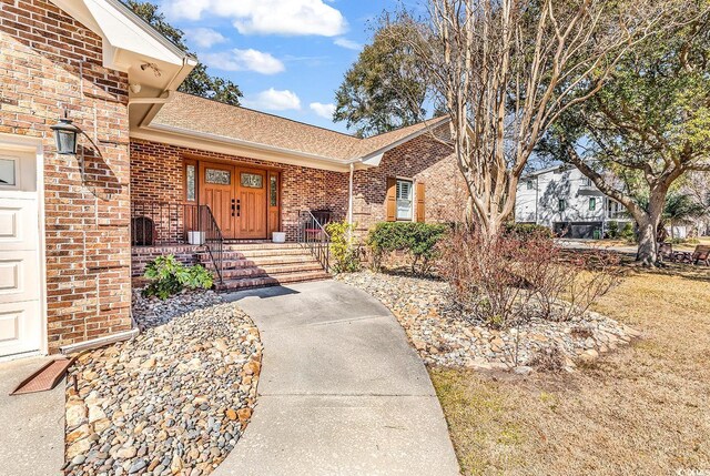 single story home featuring a garage and a front yard