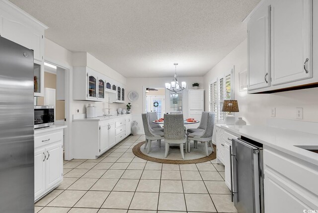 garage featuring electric panel, wood walls, refrigerator, and a garage door opener