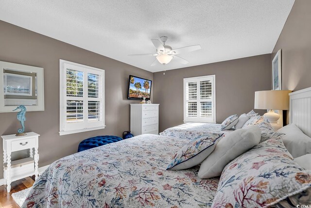 bedroom with ceiling fan, light wood-type flooring, and a closet