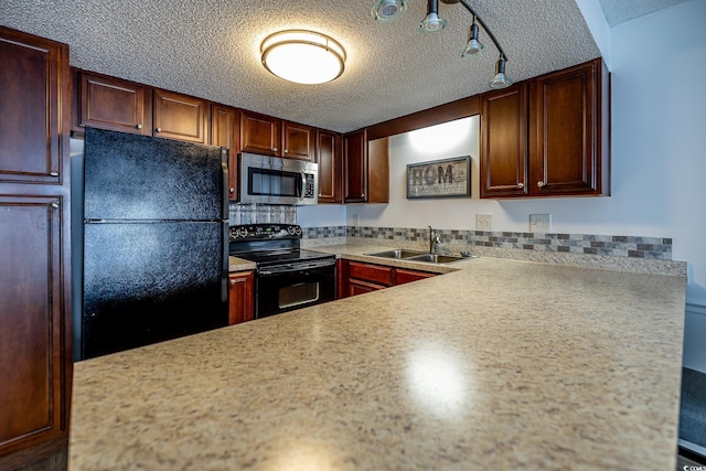 kitchen with a textured ceiling, sink, track lighting, and black appliances