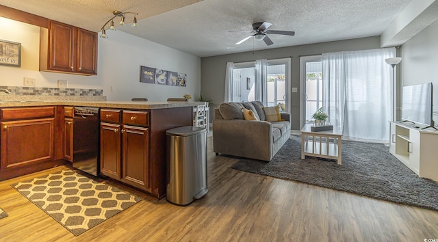 kitchen with dishwasher, hardwood / wood-style flooring, ceiling fan, a textured ceiling, and kitchen peninsula