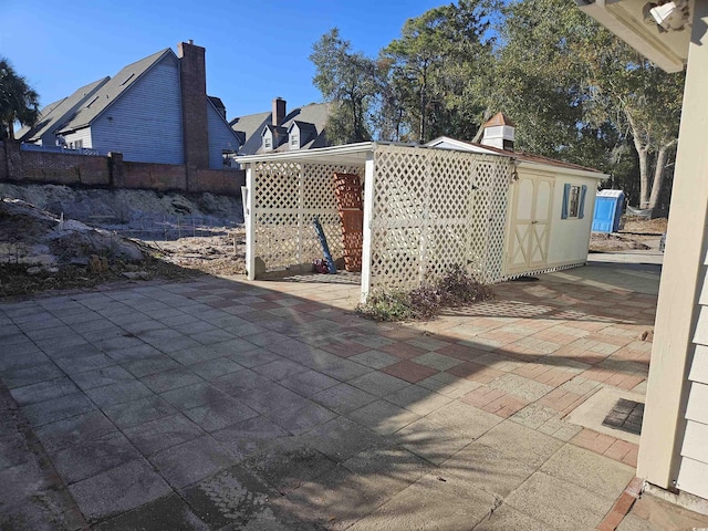 view of patio featuring a storage shed