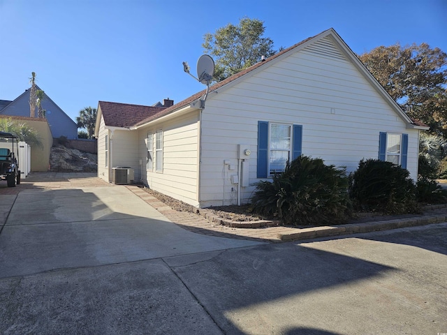 view of side of property featuring central air condition unit