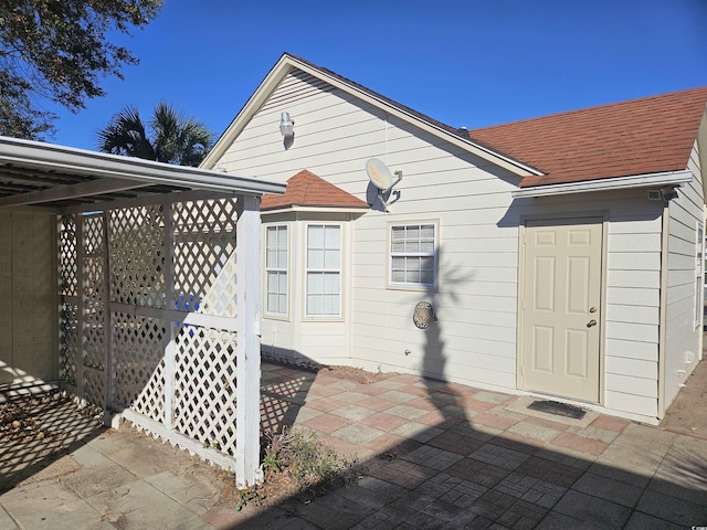 back of property with a carport