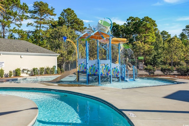 view of swimming pool with pool water feature and a patio