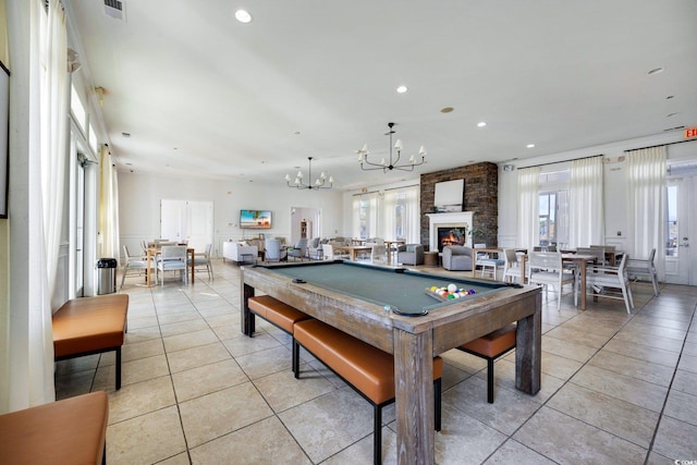 game room with a fireplace, light tile patterned floors, a healthy amount of sunlight, and billiards