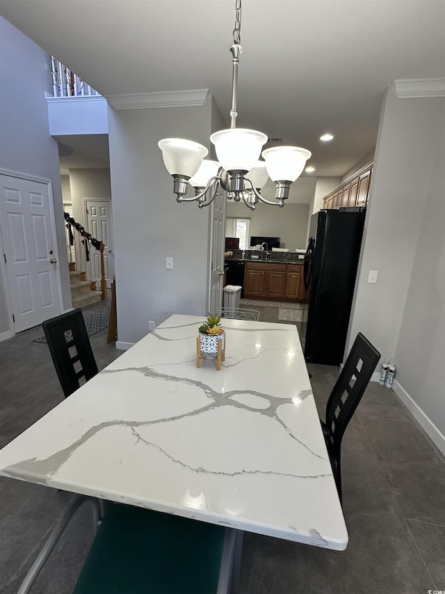 dining space with sink, a chandelier, and ornamental molding