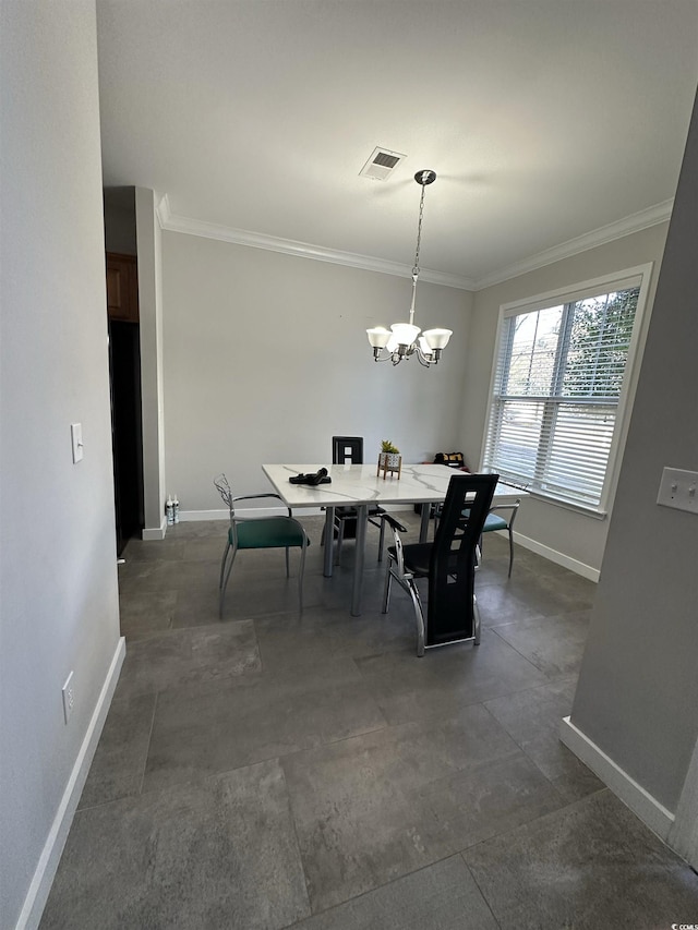 dining area with crown molding and an inviting chandelier