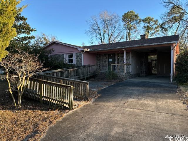 ranch-style home featuring a carport