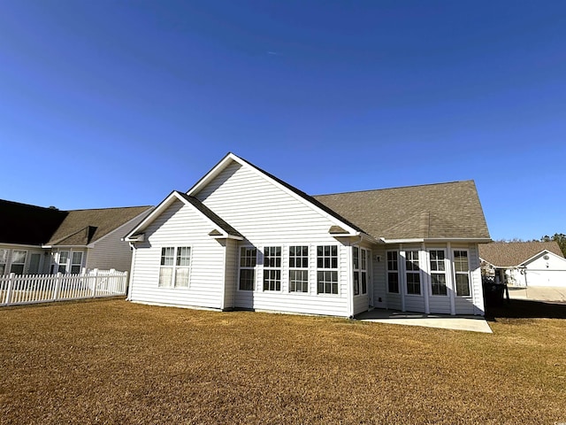 rear view of property featuring a yard and a patio