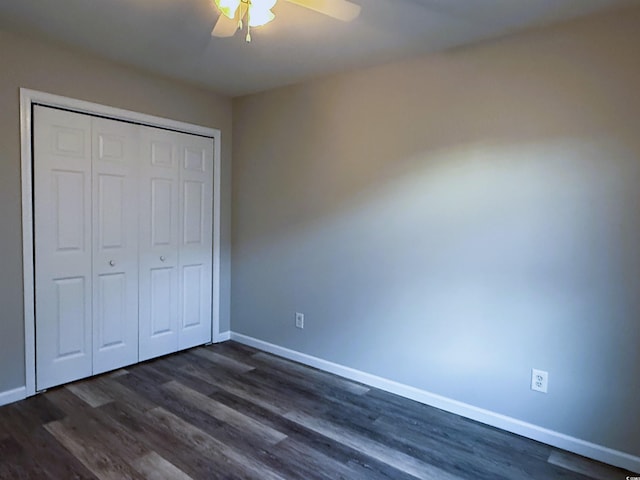 unfurnished bedroom with ceiling fan, a closet, and dark hardwood / wood-style floors