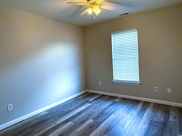 spare room with ceiling fan, dark hardwood / wood-style flooring, and a wealth of natural light