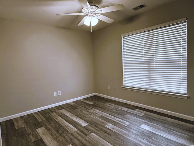 unfurnished room featuring ceiling fan and dark hardwood / wood-style flooring