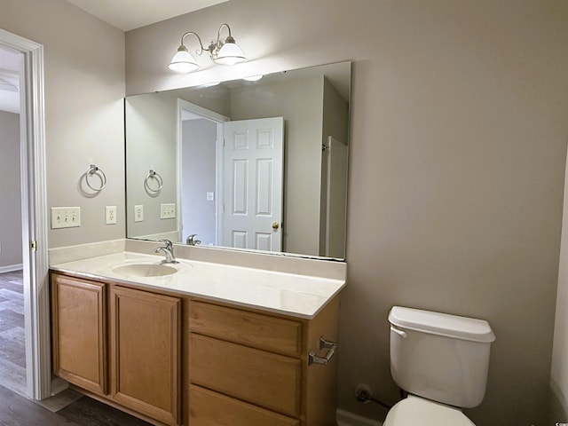 bathroom featuring hardwood / wood-style floors, vanity, and toilet