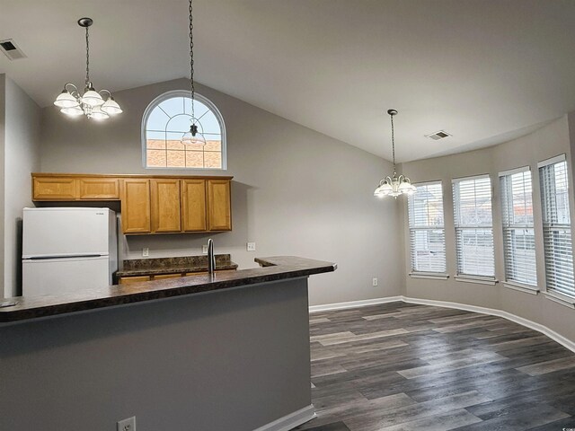 kitchen featuring sink, high vaulted ceiling, dark hardwood / wood-style floors, white fridge, and a chandelier