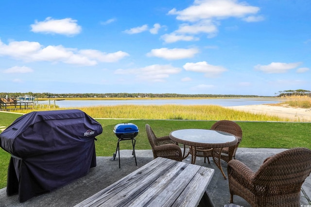 view of patio with a water view and area for grilling