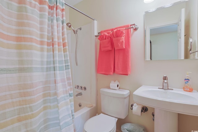 bathroom with shower / bath combo with shower curtain and toilet