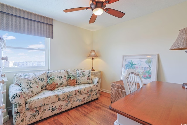 office with ceiling fan and light hardwood / wood-style flooring