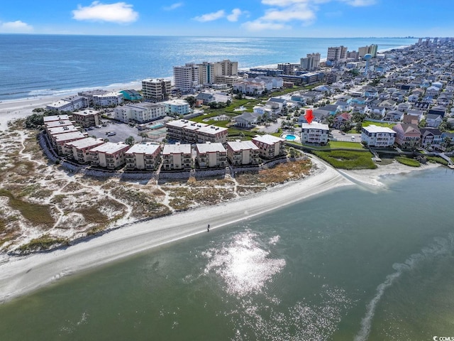 drone / aerial view featuring a water view and a beach view