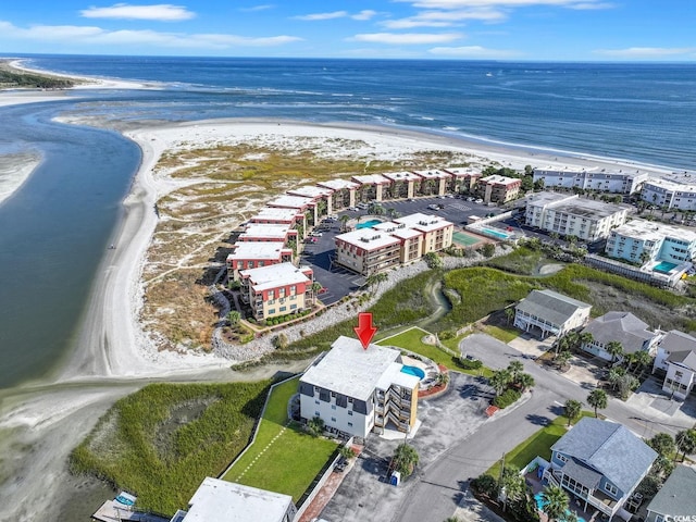 aerial view with a water view and a beach view