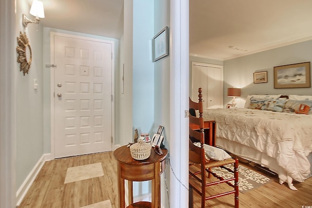 bedroom with light wood-type flooring, a closet, and ornamental molding