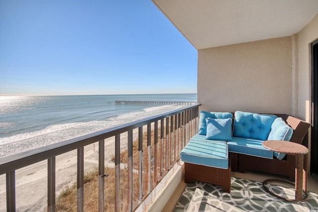 balcony with a beach view and a water view